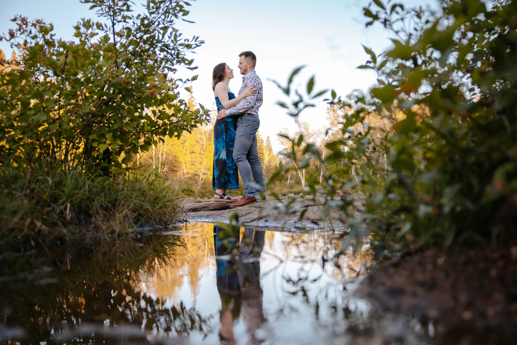 Engaged couple in a garden at golden hour